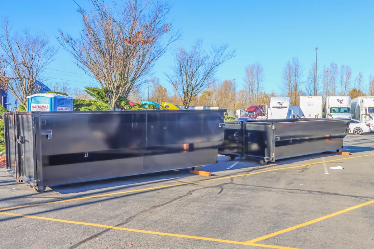 Professional dumpster rental service with roll-off container on residential driveway in Waterford